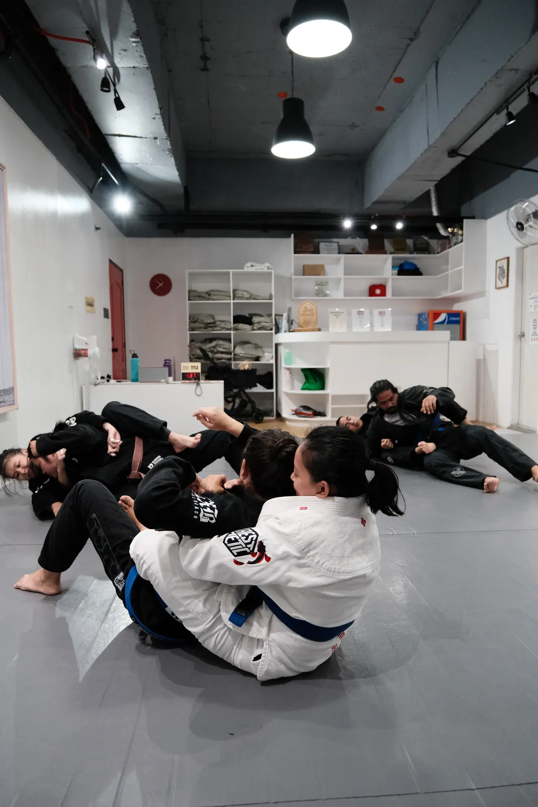 Training partners working on the mats at PLM HQ